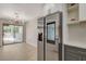 Modern kitchen with a stainless steel refrigerator, and sliding glass door to the outdoor area at 5020 Village Dr, Las Vegas, NV 89142