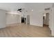 Spacious living room featuring light wood floors, recessed lighting, and an open layout to the kitchen and bathroom at 5020 Village Dr, Las Vegas, NV 89142