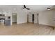 Open living room with wood floors and access to the kitchen, bathroom, and other rooms in the home at 5020 Village Dr, Las Vegas, NV 89142
