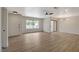 Bright living room with wood-look floors, a large window, and modern ceiling fan at 5020 Village Dr, Las Vegas, NV 89142