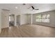 Bright living room with wood flooring, a large window, and multiple doorways leading to other rooms at 5020 Village Dr, Las Vegas, NV 89142