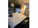 Spacious bedroom featuring two televisions, a comfortable bed, and open doorway to bathroom at 5055 W Hacienda Ave # 1161, Las Vegas, NV 89118