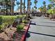 Community entrance with lush landscaping, palm trees and secured gate at the Tuscan Villas Condominiums at 5055 W Hacienda Ave # 1161, Las Vegas, NV 89118