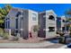 Beautiful apartment building featuring a gray stucco exterior and a terra cotta tile roof at 5055 W Hacienda Ave # 1161, Las Vegas, NV 89118