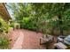 Tranquil backyard featuring a gravel pathway, mature trees, and comfortable seating, perfect for relaxing outdoors at 517 Spruce Canyon St, Las Vegas, NV 89144