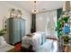 A serene bedroom features white and green decor with a massage bed and French doors leading to a beautiful view at 517 Spruce Canyon St, Las Vegas, NV 89144