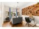 Cozy bedroom featuring a hardwood floor, a unique display wall, and modern furnishings for a comfortable retreat at 517 Spruce Canyon St, Las Vegas, NV 89144