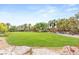 Expansive, grassy common area with trees, walkway, and desert landscaping, perfect for community enjoyment at 517 Spruce Canyon St, Las Vegas, NV 89144
