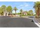 Elegant gated community entrance with manicured landscaping, featuring stone signage and archways at 517 Spruce Canyon St, Las Vegas, NV 89144