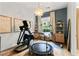Bright exercise room with a large window, a pendant light, and modern exercise equipment on hardwood flooring at 517 Spruce Canyon St, Las Vegas, NV 89144