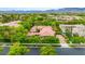 Beautiful home exterior with lush landscaping, mature trees, circular driveway, and mountain views at 517 Spruce Canyon St, Las Vegas, NV 89144