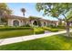 Beautiful single-story home with manicured front lawn, mature landscaping, and welcoming entrance archway at 517 Spruce Canyon St, Las Vegas, NV 89144