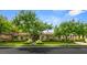 Charming single-story home showcasing arched windows and a meticulously landscaped front yard with mature trees at 517 Spruce Canyon St, Las Vegas, NV 89144