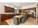 A spacious kitchen with wood cabinetry, granite countertops, and a center island with seating at 517 Spruce Canyon St, Las Vegas, NV 89144