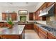 A gourmet kitchen featuring stainless steel appliances, custom cabinets, and a granite island at 517 Spruce Canyon St, Las Vegas, NV 89144