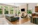 Bright living room with stone fireplace, hardwood floors, and large windows overlooking greenery at 517 Spruce Canyon St, Las Vegas, NV 89144