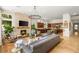 Open-concept living room and kitchen area with stone fireplace feature at 517 Spruce Canyon St, Las Vegas, NV 89144