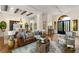 Spacious living area with a comfortable leather sofa, wooden beams, and a decorative chandelier at 517 Spruce Canyon St, Las Vegas, NV 89144