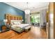 Elegant main bedroom with chandelier lighting and private access to outdoor living space at 517 Spruce Canyon St, Las Vegas, NV 89144