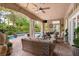 Inviting covered patio with comfortable seating, ceiling fan, outdoor TV, and access to the pool and landscaped backyard at 517 Spruce Canyon St, Las Vegas, NV 89144