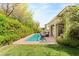 Inviting pool area with brick surround, lounge chairs, and a covered patio for relaxation at 517 Spruce Canyon St, Las Vegas, NV 89144
