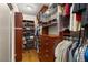 Spacious walk-in closet featuring custom shelves, wooden drawers, and hanging racks for optimal organization at 517 Spruce Canyon St, Las Vegas, NV 89144