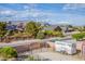Aerial view showcases a property designed for horses and rural living, set against a mountain backdrop at 5180 N Dapple Gray Rd, Las Vegas, NV 89149