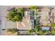 Aerial view of a private home featuring a lush yard, long driveway and desert landscape at 5180 N Dapple Gray Rd, Las Vegas, NV 89149
