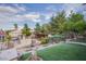 Backyard featuring green grass, mature trees, horse property, and ample outdoor space for relaxation at 5180 N Dapple Gray Rd, Las Vegas, NV 89149