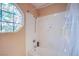 Bathroom with a stained glass window, shower head and tub at 5180 N Dapple Gray Rd, Las Vegas, NV 89149