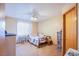 Cozy bedroom featuring neutral tones, a ceiling fan, and ample natural light from the window at 5180 N Dapple Gray Rd, Las Vegas, NV 89149