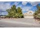 Charming home with mature landscaping, large trees, spacious driveway, and a three-car garage at 5180 N Dapple Gray Rd, Las Vegas, NV 89149
