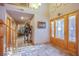 Welcoming foyer featuring wood door, staircase, and access to the garage at 5180 N Dapple Gray Rd, Las Vegas, NV 89149