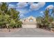 Lovely home featuring a three-car garage, desert landscaping, and a charming two-story design at 5180 N Dapple Gray Rd, Las Vegas, NV 89149