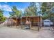 A well maintained horse stall including two horses under a roof with metal gating in the large backyard at 5180 N Dapple Gray Rd, Las Vegas, NV 89149
