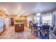 Open kitchen area with an island, wooden cabinets, and adjacent dining space for meals and gatherings at 5180 N Dapple Gray Rd, Las Vegas, NV 89149