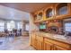 Open concept kitchen overlooking a dining area with views into the living space with brick fireplace at 5180 N Dapple Gray Rd, Las Vegas, NV 89149