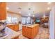 Spacious kitchen with an island, granite countertops, and modern appliances opening to living room at 5180 N Dapple Gray Rd, Las Vegas, NV 89149