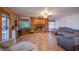 Inviting living room featuring a brick fireplace, tile floors, and a comfortable sectional sofa at 5180 N Dapple Gray Rd, Las Vegas, NV 89149