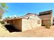 Backyard view shows the home's single-story design, backyard desert landscaping, and exterior features at 5215 Gray Ln, Las Vegas, NV 89119