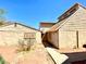 Backyard shows the property's single-story design with desert landscaping and a concrete walkway at 5215 Gray Ln, Las Vegas, NV 89119