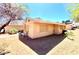 Exterior view of a single-story home with a spacious backyard, featuring desert landscaping at 5215 Gray Ln, Las Vegas, NV 89119
