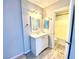 Bathroom features modern lighting, a vanity with mirror, and a tub shower combination for easy living at 5215 Gray Ln, Las Vegas, NV 89119