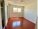 Sunlit bedroom featuring hardwood floors, a window, and a closet at 5215 Gray Ln, Las Vegas, NV 89119