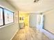 Large room featuring a window, vanity with mirror, and wood-look flooring that leads to adjoining rooms at 5215 Gray Ln, Las Vegas, NV 89119