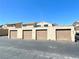 A row of garages with neutral tan doors provides convenient parking for residents in a well-maintained neighborhood at 5215 Gray Ln, Las Vegas, NV 89119