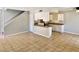 Inviting living area seamlessly connected to a kitchen with tile floors and staircase at 5215 Gray Ln, Las Vegas, NV 89119
