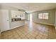 Spacious living room and kitchen with tiled flooring and a sliding glass door to the outdoors at 5215 Gray Ln, Las Vegas, NV 89119