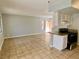 Open living space with tile flooring and natural light, flowing into the kitchen with white cabinetry at 5215 Gray Ln, Las Vegas, NV 89119