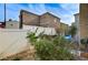 Enclosed backyard featuring a white fence, tasteful gravel and drought tolerant landscaping at 5228 Fire Night Ave, Las Vegas, NV 89122
